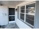 Charming front entryway with vintage mailbox, storm door, and a classic outdoor lantern at 7552 Cumber Dr, New Port Richey, FL 34653