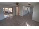 Open-concept living area featuring tile flooring and access to a screened patio and full bathroom at 7552 Cumber Dr, New Port Richey, FL 34653