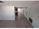 Open-concept living space with tile flooring offering a view into the kitchen and dining area at 7552 Cumber Dr, New Port Richey, FL 34653