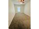 Simple bedroom with neutral carpet and a ceiling fan at 27173 Simona Ave, Brooksville, FL 34602