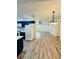 Kitchen boasts dark blue cabinets, white appliances, and wood-look floors at 27173 Simona Ave, Brooksville, FL 34602