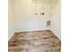 Laundry room with wire shelving and wood-look flooring at 27173 Simona Ave, Brooksville, FL 34602