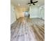 Spacious living room featuring wood-look floors and a ceiling fan at 27173 Simona Ave, Brooksville, FL 34602