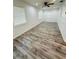Bright and airy living room with wood-look floors and ceiling fan at 27173 Simona Ave, Brooksville, FL 34602