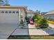 Two-car garage with decorative accents and a landscaped area at 11654 Holly Ann Dr, New Port Richey, FL 34654