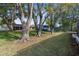 Spacious backyard with mature trees and grassy area at 12216 Silk Oak Ln, Hudson, FL 34667