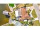 Aerial view with dock, boat lift, patio and lush landscaping at 12832 3Rd Isle, Hudson, FL 34667