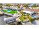 Aerial view showcasing a pool, green turf, and dock with boat lift at 12832 3Rd Isle, Hudson, FL 34667