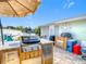 Backyard area featuring an outdoor kitchen, bar, and grill, perfect for entertaining at 12832 3Rd Isle, Hudson, FL 34667