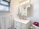 Modern bathroom with vanity, updated fixtures, stylish mirror and natural light from adjacent window at 12832 3Rd Isle, Hudson, FL 34667