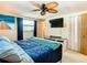 Comfortable bedroom features ceiling fan and a mounted television at 12832 3Rd Isle, Hudson, FL 34667