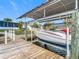 Side view of a covered boat lift with sturdy wood construction at 12832 3Rd Isle, Hudson, FL 34667