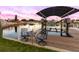 Inviting waterfront dock with table and chairs, offering a scenic spot to unwind and watch the sunset at 12832 3Rd Isle, Hudson, FL 34667