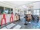Bright, enclosed patio featuring ample seating and tables for entertaining while overlooking the water at 12832 3Rd Isle, Hudson, FL 34667