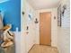 Bright foyer with a coastal design, featuring nautical accents, a decorative pelican statue, and tile flooring at 12832 3Rd Isle, Hudson, FL 34667