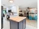 Open kitchen flows into a bar and entertainment area with a large island at 12832 3Rd Isle, Hudson, FL 34667
