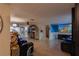 Open living space boasts tile floors, coastal decor, and a seamless flow to the kitchen and dining areas at 12832 3Rd Isle, Hudson, FL 34667