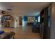 Open-concept living room with tile floors, a fireplace, entertainment center, and bright, blue accent wall at 12832 3Rd Isle, Hudson, FL 34667