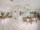 Bright dining area with wood table and chairs, open to living room at 2027 Beckwith Ave, Spring Hill, FL 34608