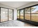 Enclosed patio with access to backyard and gray tile floors at 2027 Beckwith Ave, Spring Hill, FL 34608