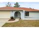 Inviting exterior with a terracotta roof and well-maintained lawn at 2027 Beckwith Ave, Spring Hill, FL 34608