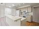 Functional kitchen with white appliances and wood floors at 2027 Beckwith Ave, Spring Hill, FL 34608