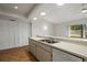 Bright kitchen features double sink, dishwasher, and white cabinetry at 2027 Beckwith Ave, Spring Hill, FL 34608