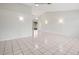 Spacious living room with tile floors and access to patio at 2027 Beckwith Ave, Spring Hill, FL 34608