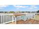 Private deck overlooking the water with a wooden table and chairs at 3465 Gulf Coast Dr, Hernando Beach, FL 34607