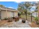Cozy patio with fire pit and seating area, partially fenced backyard at 37351 Neighbors Path, Zephyrhills, FL 33542