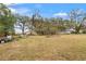 Large backyard with fallen tree and grassy area at 37351 Neighbors Path, Zephyrhills, FL 33542