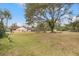 Large backyard with mature trees and grassy areas at 37351 Neighbors Path, Zephyrhills, FL 33542