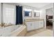 Bathroom with double vanity, soaking tub, and separate shower at 37351 Neighbors Path, Zephyrhills, FL 33542