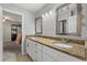 Double vanity bathroom with granite countertop and mirrors at 37351 Neighbors Path, Zephyrhills, FL 33542