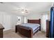 Main bedroom with king-size bed and access to bathroom at 37351 Neighbors Path, Zephyrhills, FL 33542