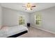 Bedroom with twin bed and two windows at 37351 Neighbors Path, Zephyrhills, FL 33542