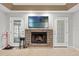 Stone fireplace with TV above, flanked by doors at 37351 Neighbors Path, Zephyrhills, FL 33542