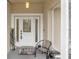 Screened porch with seating area and entryway at 37351 Neighbors Path, Zephyrhills, FL 33542