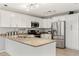 Modern kitchen with white cabinets and granite counters at 37351 Neighbors Path, Zephyrhills, FL 33542