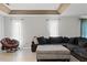 Living room with sectional sofa and a papasan chair at 37351 Neighbors Path, Zephyrhills, FL 33542