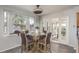 Bright dining area with glass table and four chairs, access to a sunroom at 5406 Captains Ct, New Port Richey, FL 34652