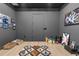 Basement space with gray walls, an area rug, and assorted decor, offering versatile living space at 7376 Fall St, Brooksville, FL 34613