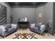 Basement lounge area with stylish gray chairs, a rug, and modern decor, perfect for relaxation and entertainment at 7376 Fall St, Brooksville, FL 34613