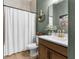 Charming bathroom featuring modern fixtures, an elegant shower curtain, and rustic-chic decor at 7376 Fall St, Brooksville, FL 34613