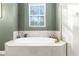 Serene bathroom featuring an octagonal soaking tub with tile surround, next to glass-enclosed shower at 7376 Fall St, Brooksville, FL 34613