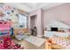Bright bedroom with floral wallpaper, unique furniture, and laminate wood flooring at 7376 Fall St, Brooksville, FL 34613