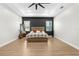 Bright bedroom with a tray ceiling, fan, and accent wall, creating a welcoming atmosphere at 7376 Fall St, Brooksville, FL 34613