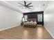 Spacious bedroom featuring a tray ceiling, modern fan, and neutral color palette at 7376 Fall St, Brooksville, FL 34613