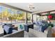Covered patio with outdoor seating, a firepit, and views of the large fenced in backyard and pool at 7376 Fall St, Brooksville, FL 34613