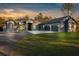 Beautiful home with a long driveway and three-car garage at sunset at 7376 Fall St, Brooksville, FL 34613
